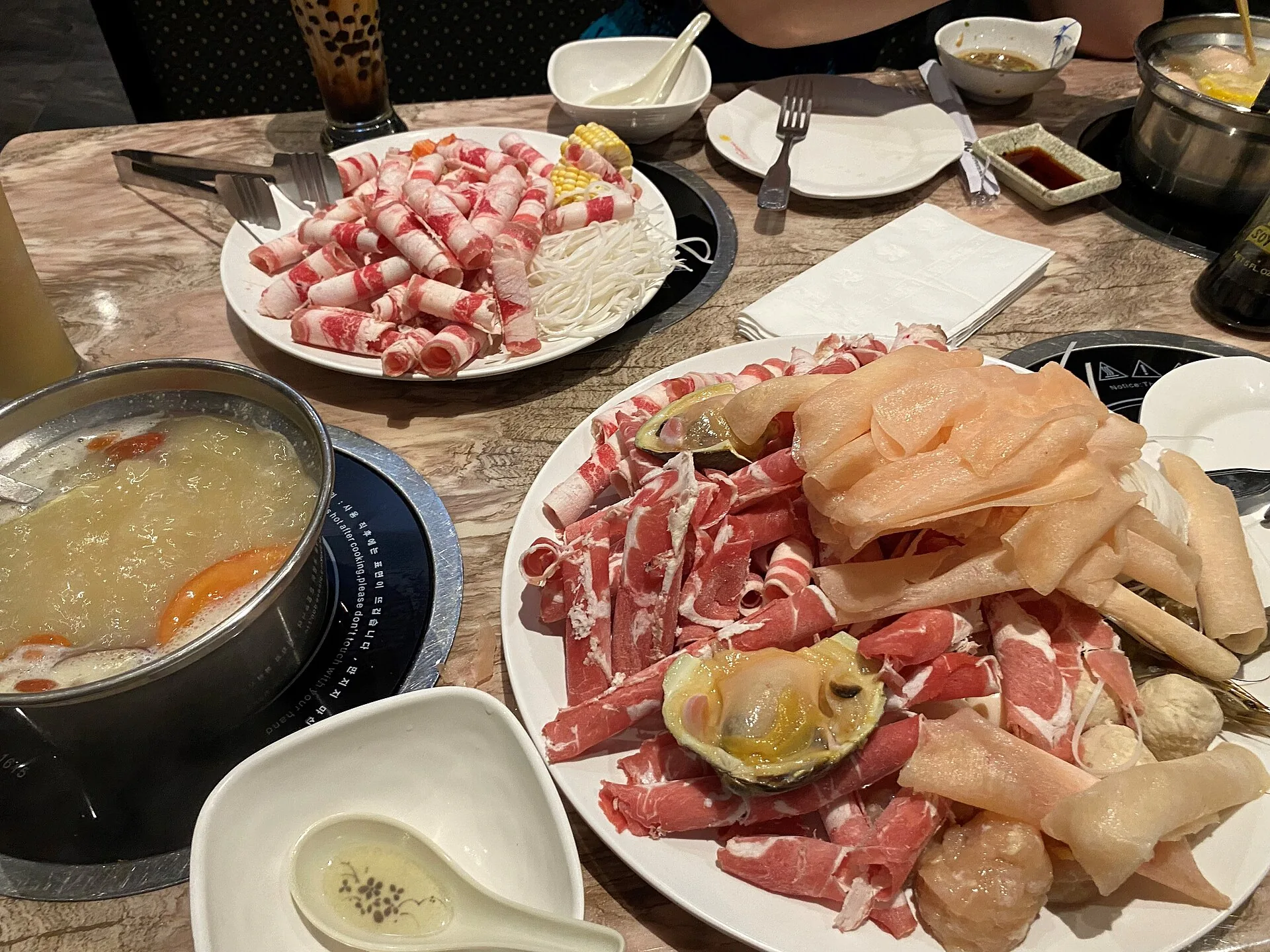 Chinese food shared around a hot pot table